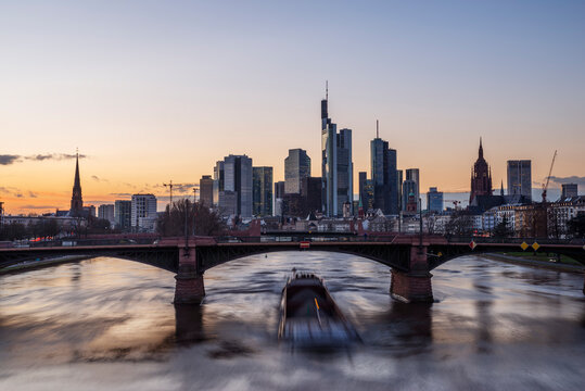 Germany, Hesse, Frankfurt, Ignatz Bubis Bridge at dusk with downtown skyline in background