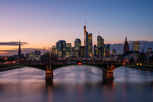 Germany, Hesse, Frankfurt, Ignatz Bubis Bridge at dusk with downtown skyline in background