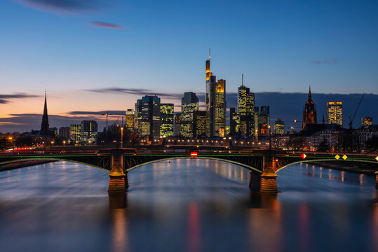 Germany, Hesse, Frankfurt, Ignatz Bubis Bridge at dusk with downtown skyline in background