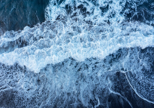 Drone view of waves brushing sand ofPraia de Santa Barbara