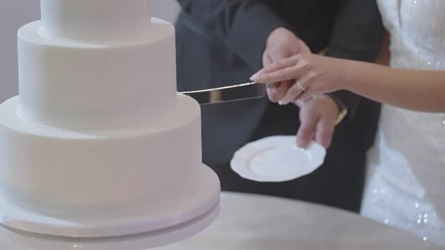 Bride and Groom cutting the wedding cake together