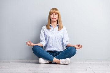 Full size photo of lady representative rest office meditate quiet sit floor legs crossed position isolated grey color background - obrazy, fototapety, plakaty