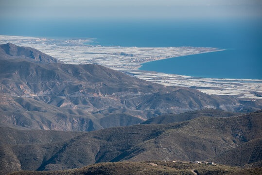 view of the greenhouses of western almeria from the mountains. You can see the villages of Balanegra, Balerma, Guardias Viejas and Almerimar surrounded by the agriculture of a sea of plastic