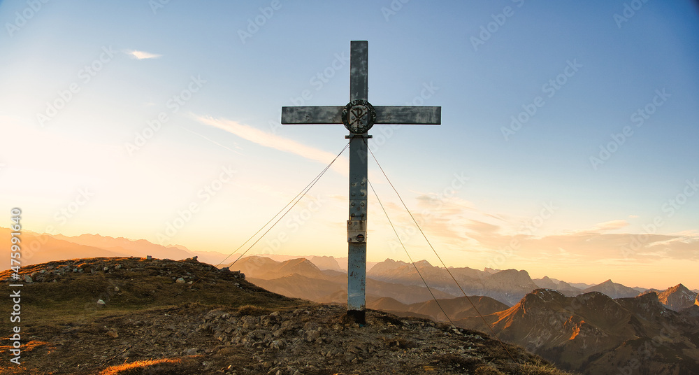 Sticker Scenic shot of the Goesseck summit cross during the sunset at Eisenerzer Alps