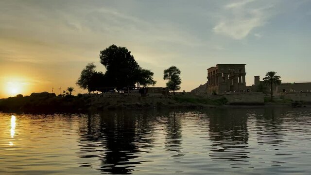Beautiful Philae temple of love at sunset light the beautiful temple of Philae and the Greco-Roman buildings are seen from the Nile river a temple dedicated to Isis, goddess of love Aswan Egyptian