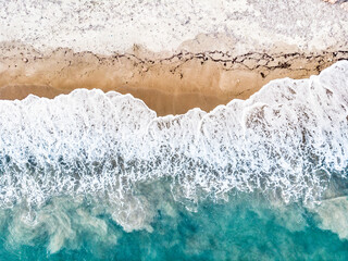 Fototapeta na wymiar Aerial view. Sea waves and sandy beach