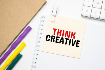 Think Creative. Notebook on laptop keyboard, on light background