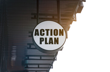 There is a circular sign under the roof of the building that says - ACTION PLAN