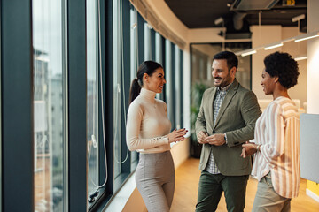 Company employees, having a meeting in the open space office and talking.