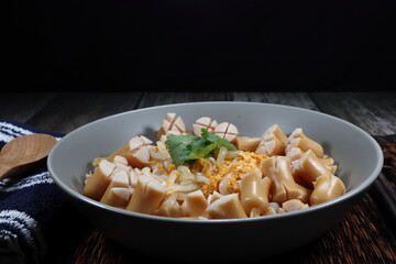 Spicy fried rice noodle topping with pork sausage serving on the plate. Famous street food menu in Asia restaurant. 