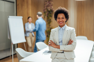 Portrait of professional african-american woman, feeling relaxed at the office.
