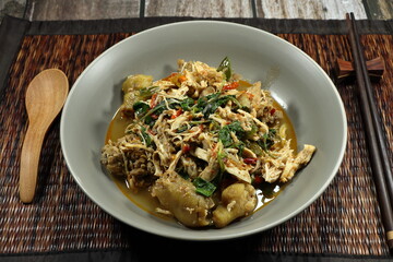 Traditional spicy fried chicken with basil and chilly serving on the plate. Famous hot and spicy menu in Asia restaurant. 