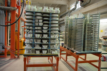 Ceramic cups on racks before putting into the oven 