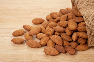 Almonds on wooden background. Healty food concept.