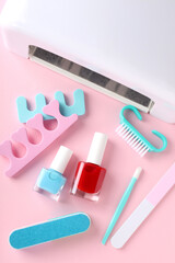 Concept of nail care with manicure accessories on pink background