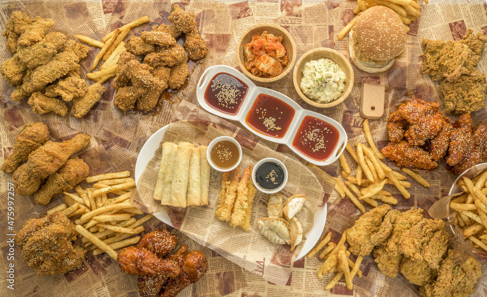 Sticker top view of an assortment of fried dishes on the papers surface