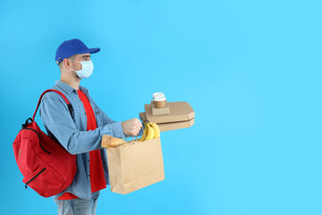 Delivery man with food on blue background