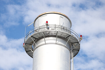 Close-up industrial view photo of metallic chimney tower.
