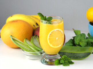 Detox smoothie Aloe Vera with mango, grapefruit and banana in a glass on a white background