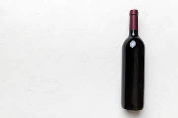 One Bottle of red wine on colored table. Flat lay, top view wth copy space