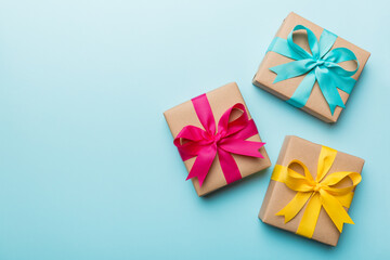 Holiday present box over colored background, top view