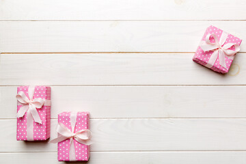 Valentine day composition: red gift box with bow and heart. Christmas present. View from above. Space for text. Holday greeting card