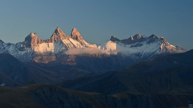 A time lapse of snowy mountains Aiguilles d'Arves from Col de la Croix de Fer, Savoie, France