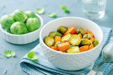Roasted Sweet potato and Brussels Sprouts on a wood background