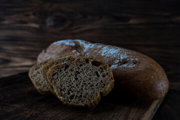 Gray appetizing loaf on a wooden background