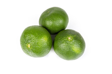 Ripe tangerines of green variety on a white background