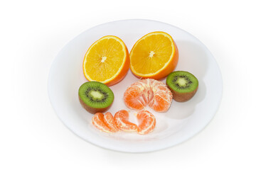 Halves of orange and kiwifruit, tangerine segments on white dish