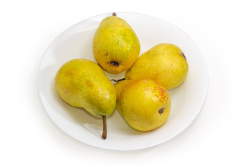 Yellow pears on dish on a white background