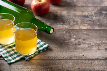 Apple cider drink on rustic wooden table. Copy space