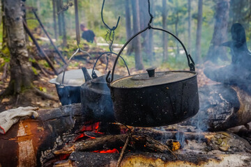 Cooking in a pot over a fire in the taiga