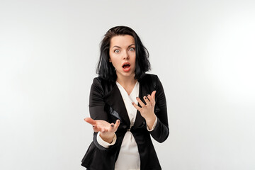 businesswoman in black formal jacket with big eyes wondering standing over white background....