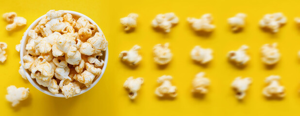 Popcorn viewed top Paper cup with popcorn on white isolated , yellow popcorn