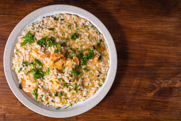 Portion of shrimp risotto on a plate, close-up, top view, copy space