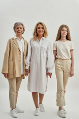 Beautiful three females standing and holding hands