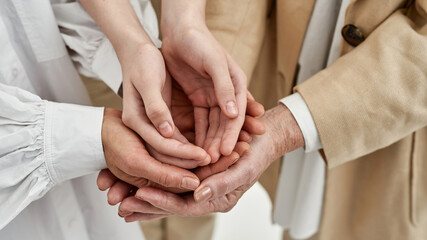 Partial view of female relatives holding hands