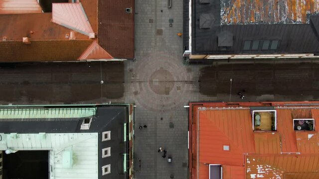 Colorful Swedish town center with people walking, aerial top down view