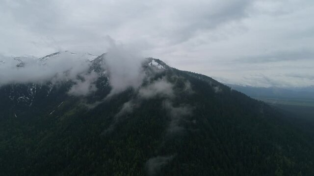Foggy misty mountain landscape with fir forest and in vintage retro hipster style, Baikalsk. Lake Snezhnoe.