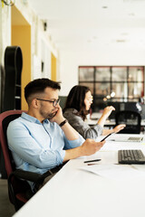 Colleagues in office. Businesswoman and businessman discussing work in office. Two friends working together