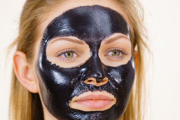 Girl black carbo peel off mask on face