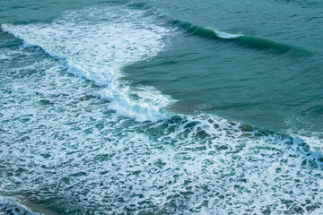 Fototapeta na wymiar Large wave splashing in blue sea