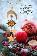 Winter Solstice. golden amulet, Wiccan Solstice symbol and red candle, winter festive decor on windowsill. Witchcraft Ritual, Esoteric spiritual practice concept. Yule, Magical sabbat - obrazy, fototapety, plakaty