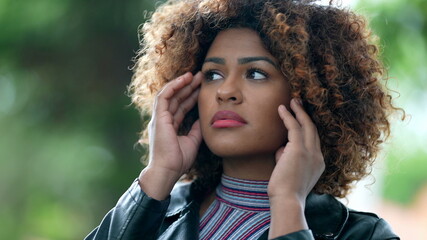 Pensive worried black woman face close-up. Person feeling anxiety and depression