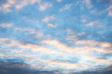 beautiful sunset sky with cirrus and cumulus clouds in late autumn or early winter with long rays of the setting sun