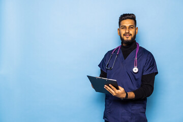 Fototapeta na wymiar Indian male doctor holding a blank clipboard and looking at him. Surgeon concept.