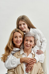Pleased three female generations hug each other