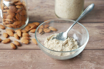 almond powder and almond in a jar on table,